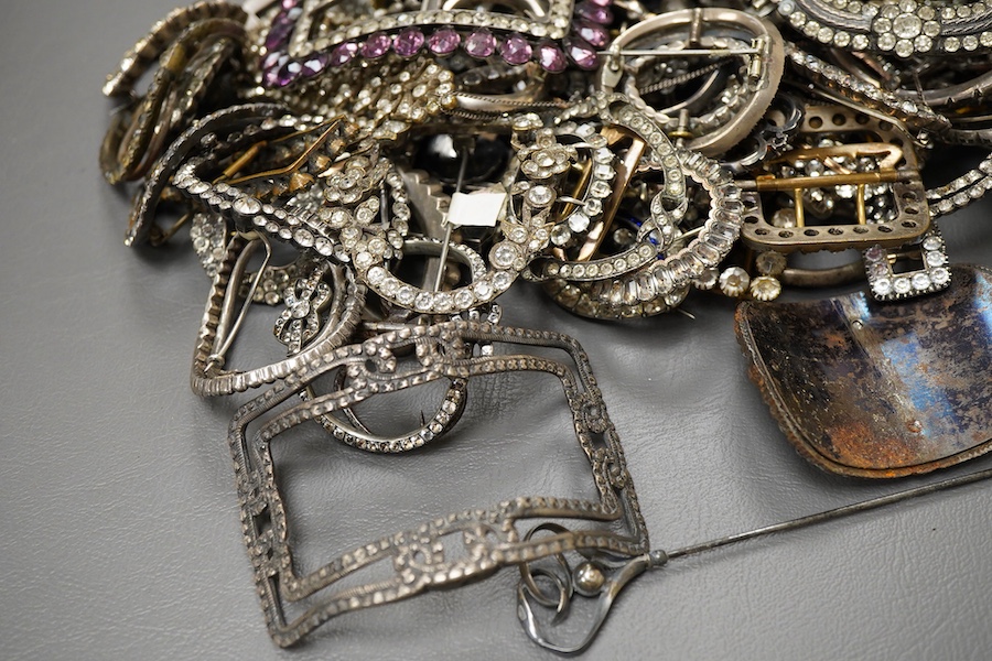 A large collection of buckles, 18th-early 20th century, of oval and rectangular outline, set with pastes, some with cut steel, mostly mounted in steel, a minority in silver, some with later brooch fittings
